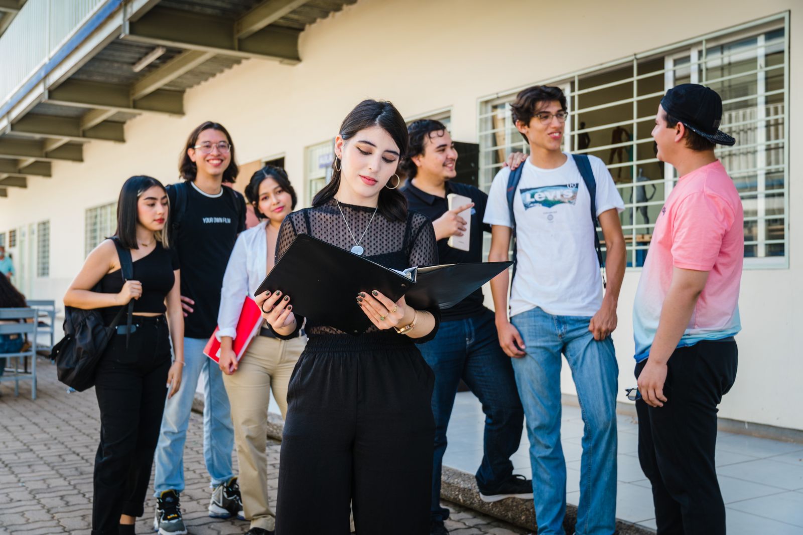 Group of Latinx students gathered outside their high school